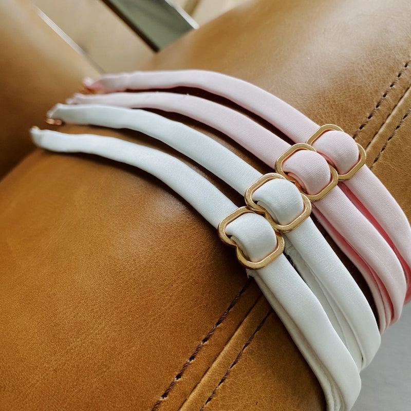 White and pink bra shoulder straps
